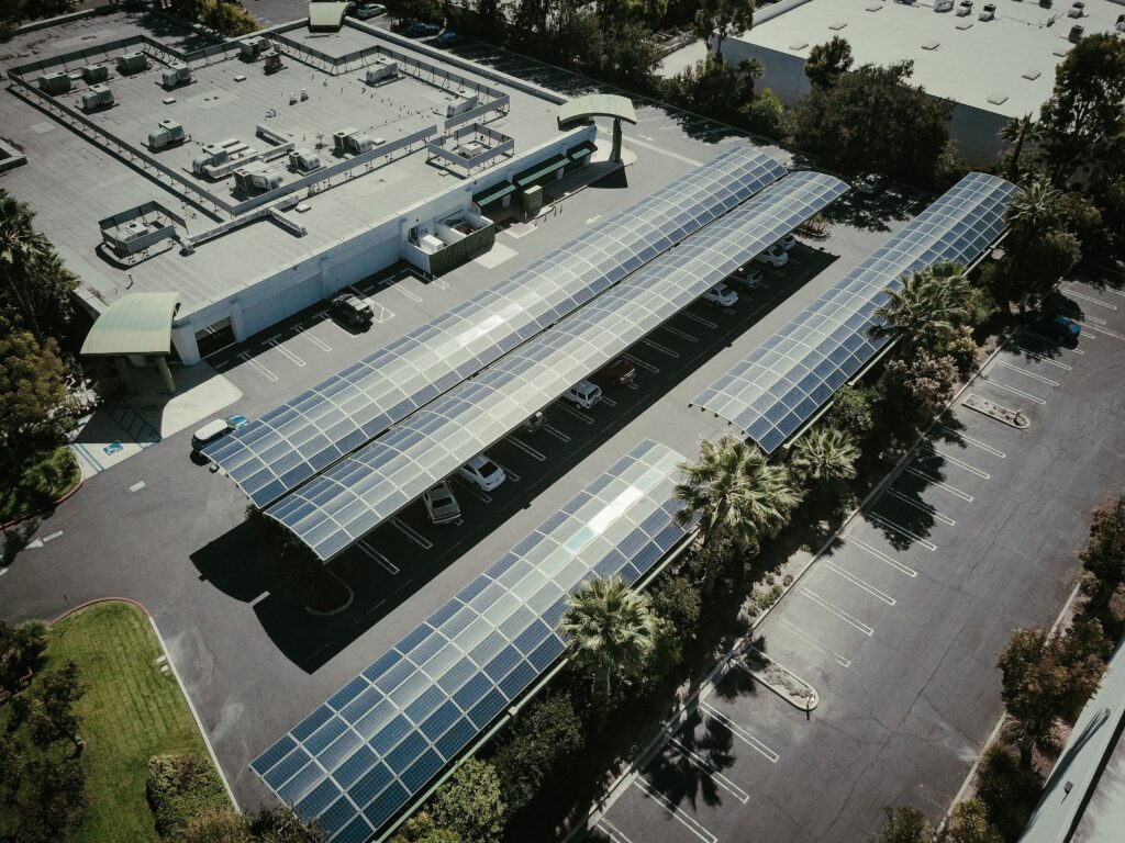 Technician installing solar panels on a rooftop mounting structure