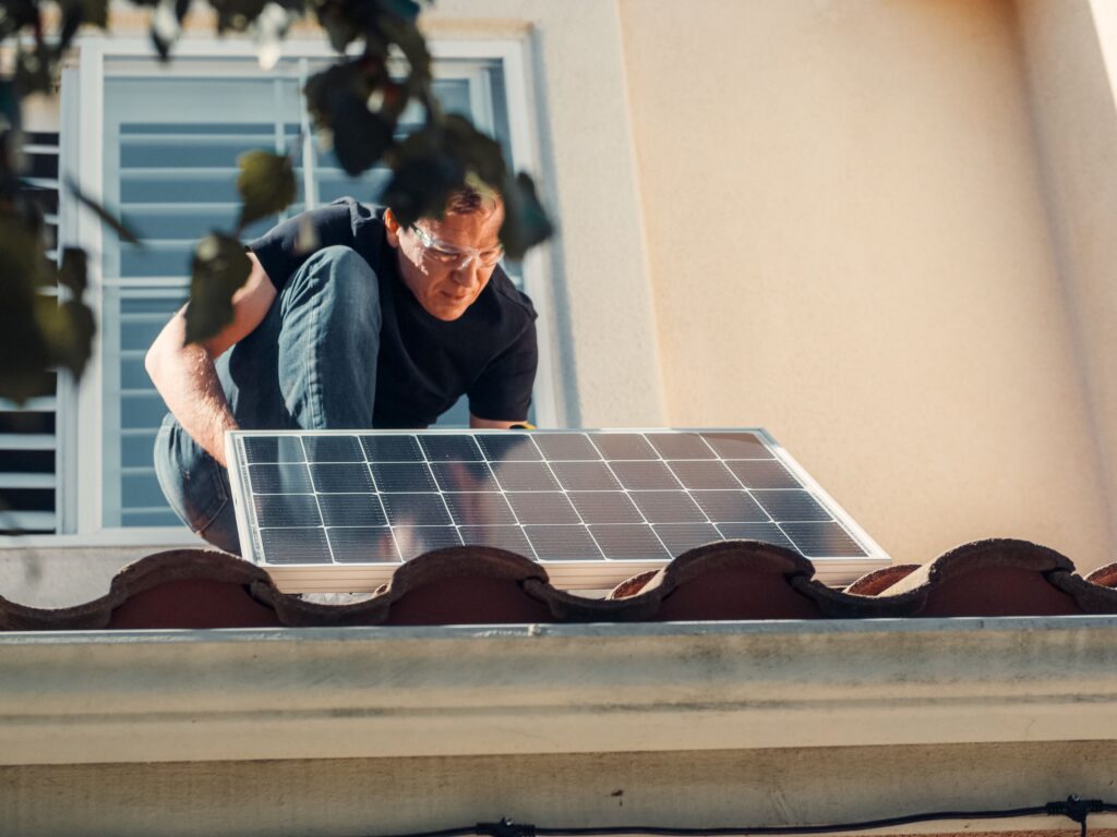 Solar panels being installed on a small commercial building