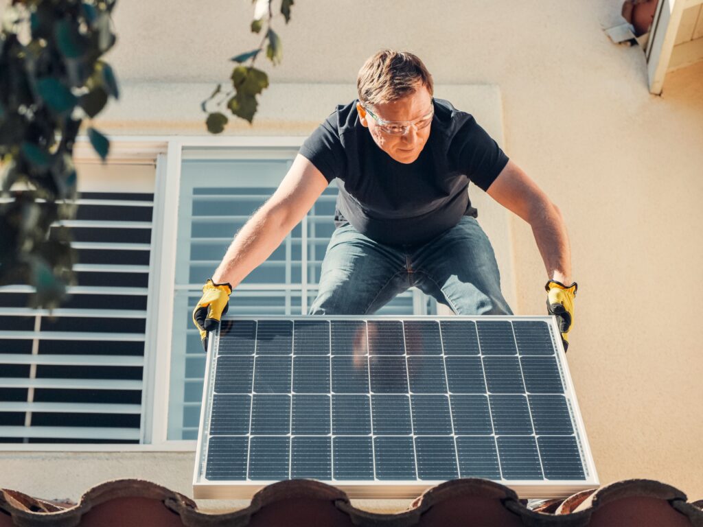 Engineers installing solar panels on a rooftop mounting structure